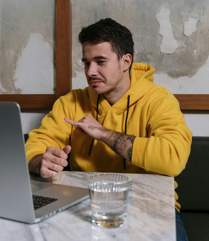 person on laptop using sign language